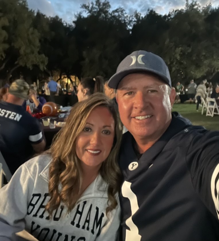 Jeff and a companion smiling in BYU gear